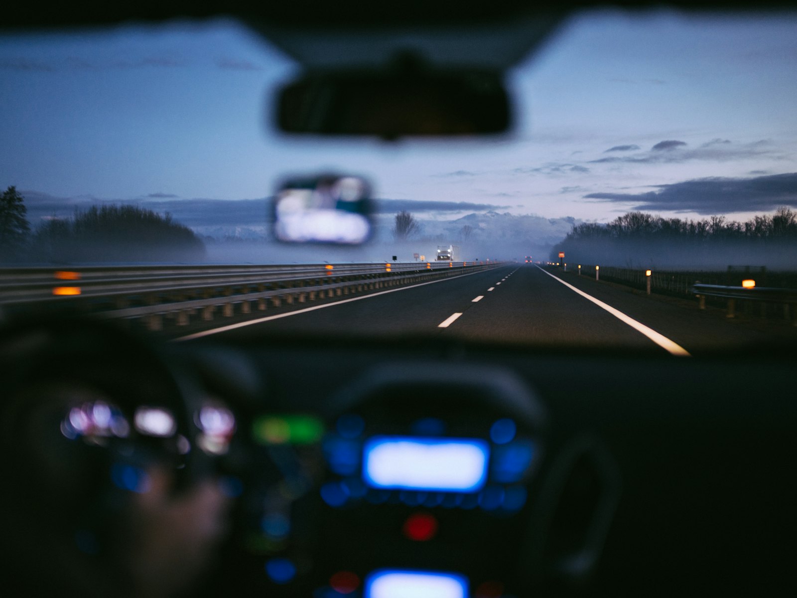 A dual carriageway at dusk, seen from the driving seat